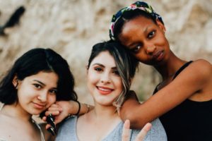 International women's day, 3 girls of different race standing together.