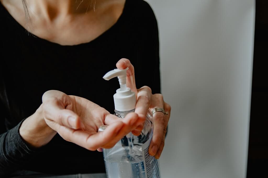 women using hand sanitiser