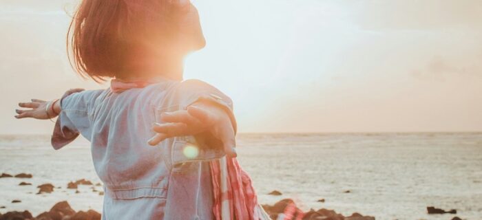 setting intentions to create a life you love. woman standing on beach.